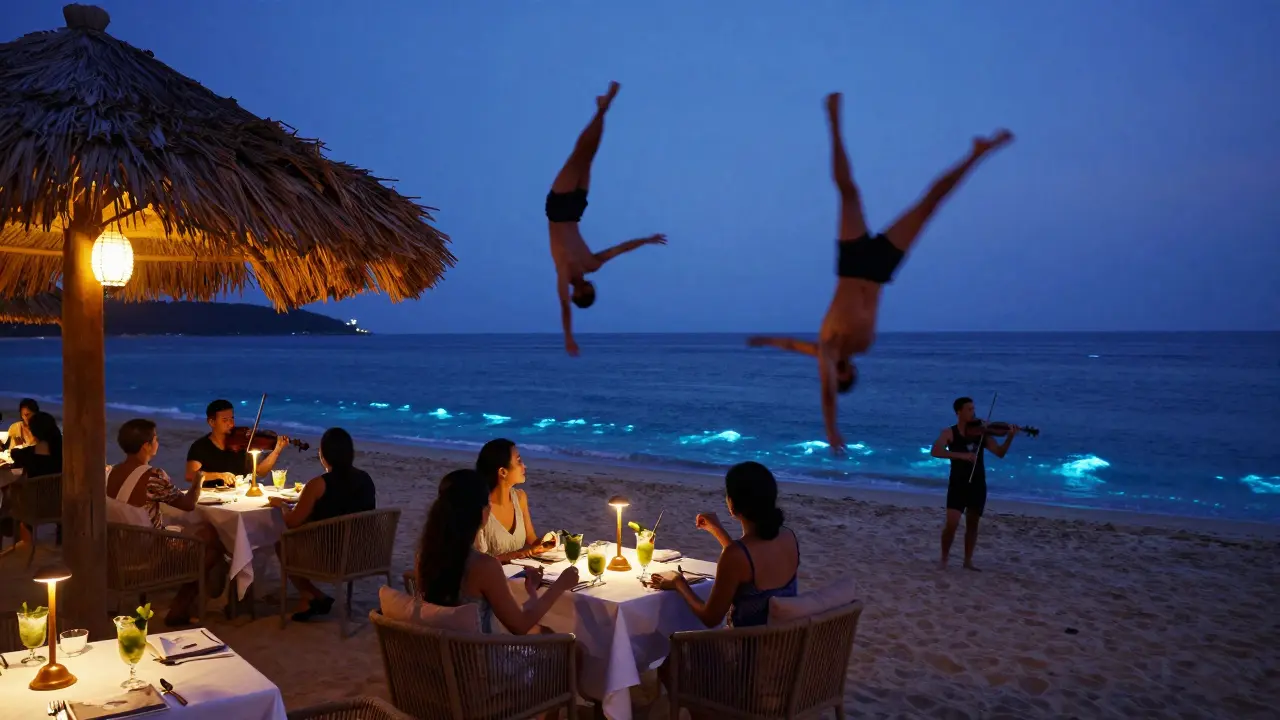 Acrobats perform above diners at La Perle Beach as violinist plays during twilight.